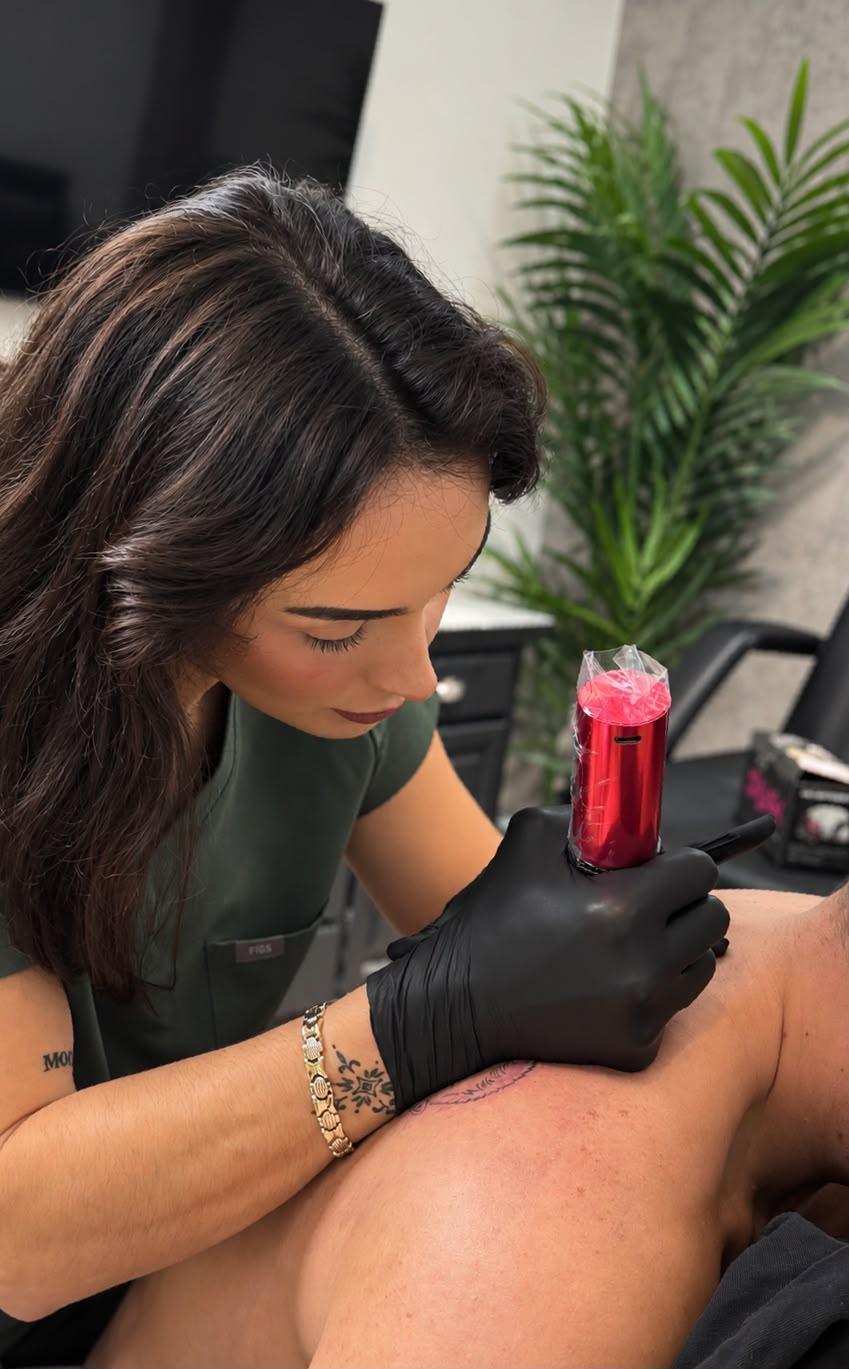 Amy tattooing a client's leg